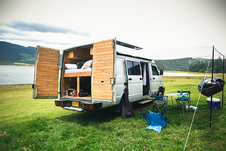 Camper van with fixed bed and storage