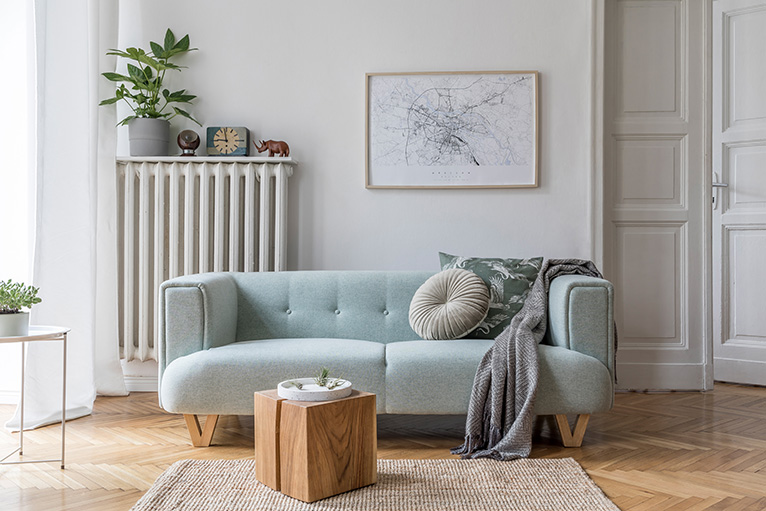 Scandinavian living room interior with design mint sofa, furnitures, mock up poster map, plants, and elegant personal accessories.