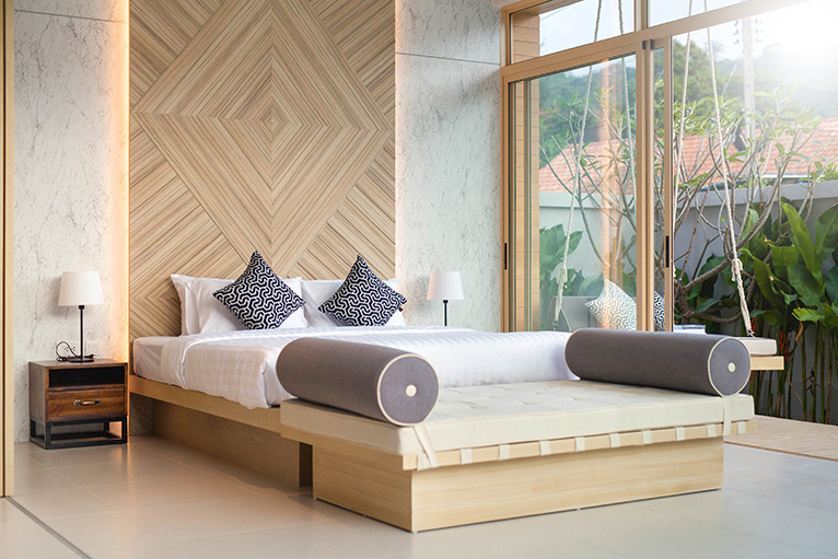 Cosy king bed with wood wall decor