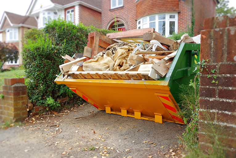 Building waste in skip outside house