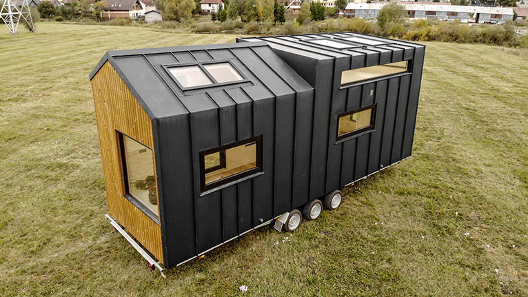 Mobile tiny home parked on land