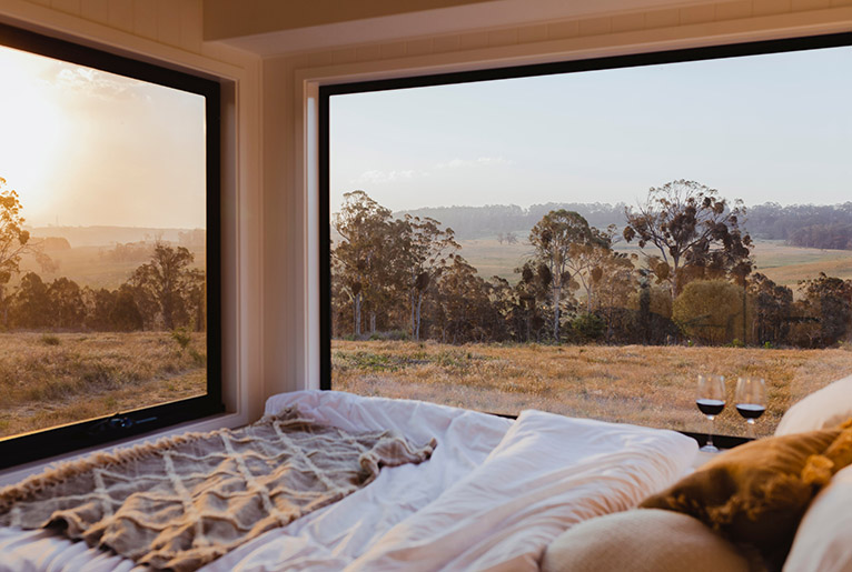 View into the countryside from a tiny home bedroom