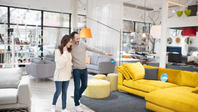 Couple looking at modern living room furniture in shop