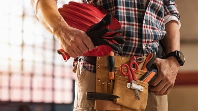 Tradesperson carrying tools in tool belt