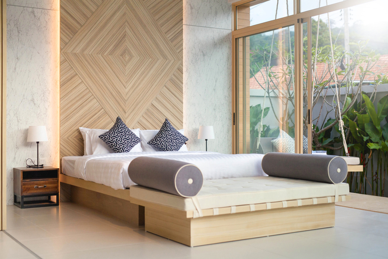 Wooden wall panel with recessed lights being used as a headboard