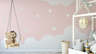 Pink nursery wall decorated with clouds and stars