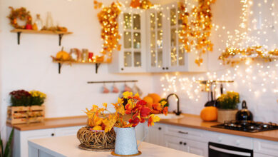 Halloween themed interior with orange and red leaves and fairy lights.