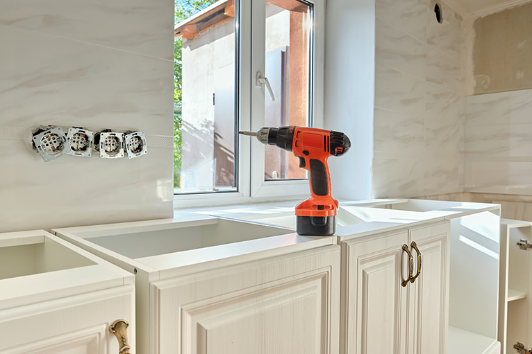 Screw driver sitting on kitchen countertop during a renovation.