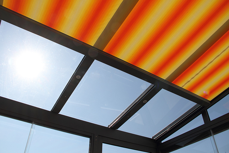 Orange and yellow striped conservatory ceiling blinds.