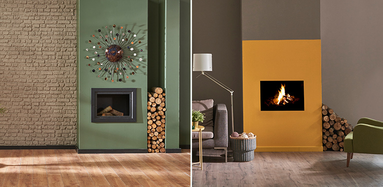 Electric fire place inside a colourful wall painted a bright shade of mustard yellow.
