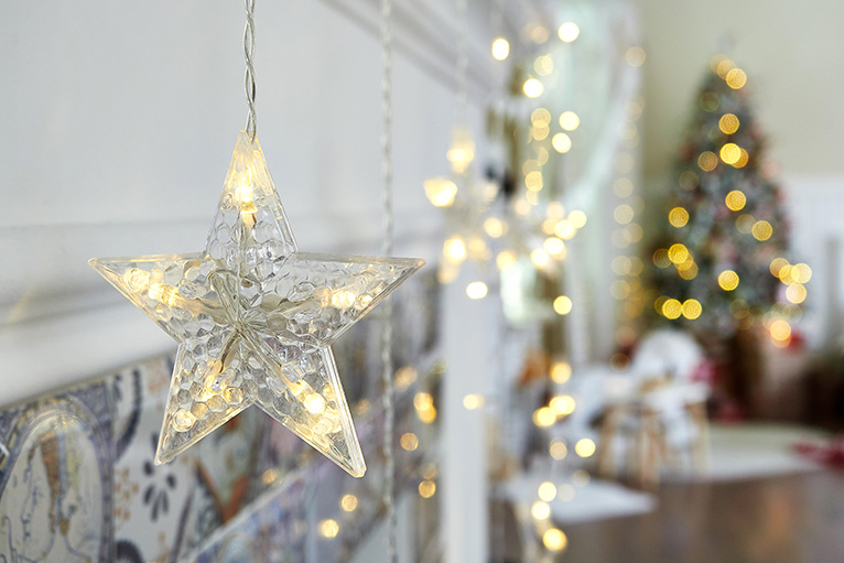 Christmas lights lit-up on a Christmas tree and star decoration. 