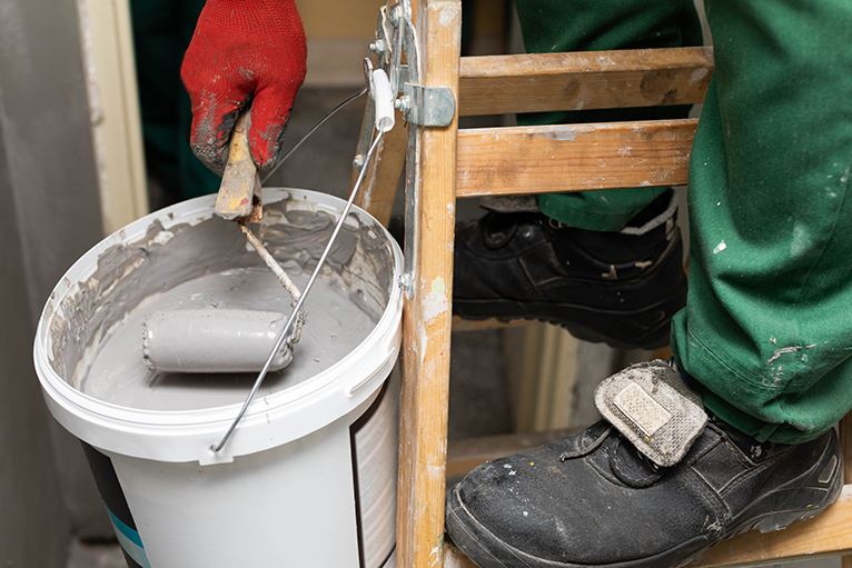 Picture of a tradesperson applying damp proof paint