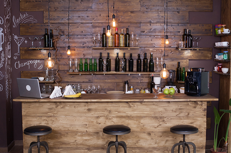 Home bar counter with wine bottles.