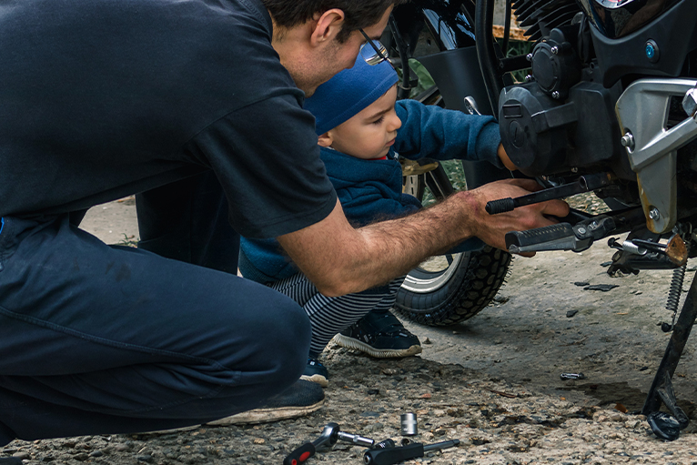 Picture of a father and son fixing a bike