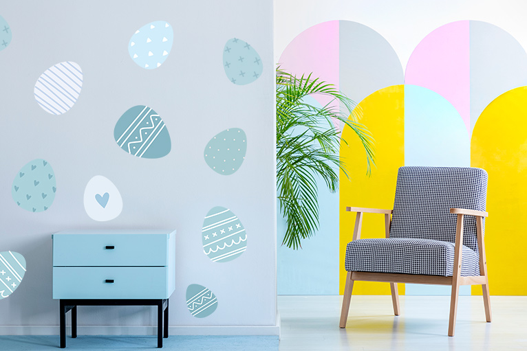 Easter eggs painted on an interior grey wall
