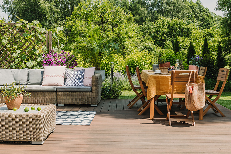 Outdoor entertaining area with wooden decking, garden furniture, dining table and chairs
