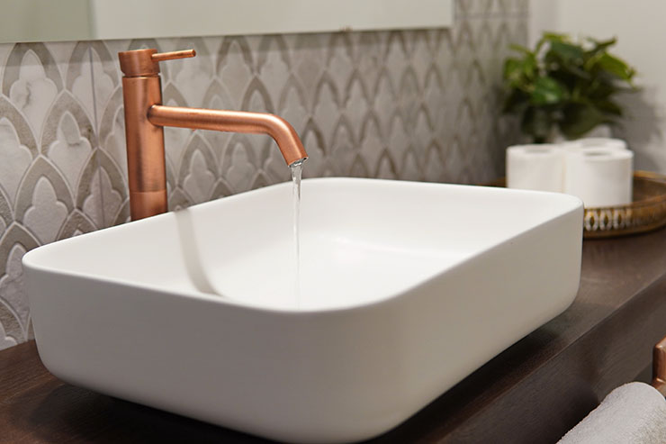 Photo of a minimalist, modern bathroom sink with chrome faucet.