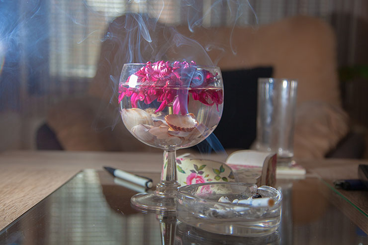 Glass bowls like decoration in a room with ashtray and cigarettes