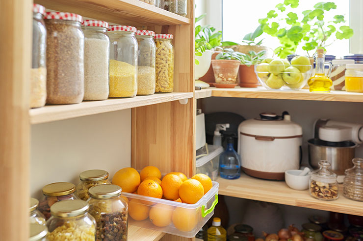 Image of a kitchen pantry sticked with shelves full of jars and containers of food