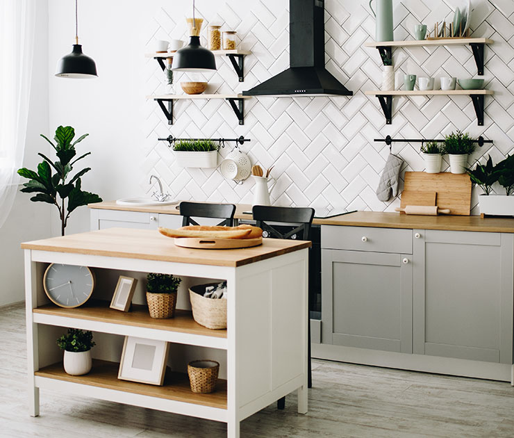 Image of a Scandinavian kitchen design, with bright tiles, modern interior and wooden countertops.