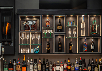 Picture of a home bar with alcohol and glasses