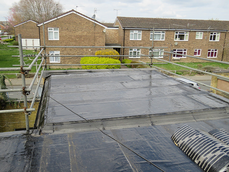 Picture of a flat roof in the process of being replaced