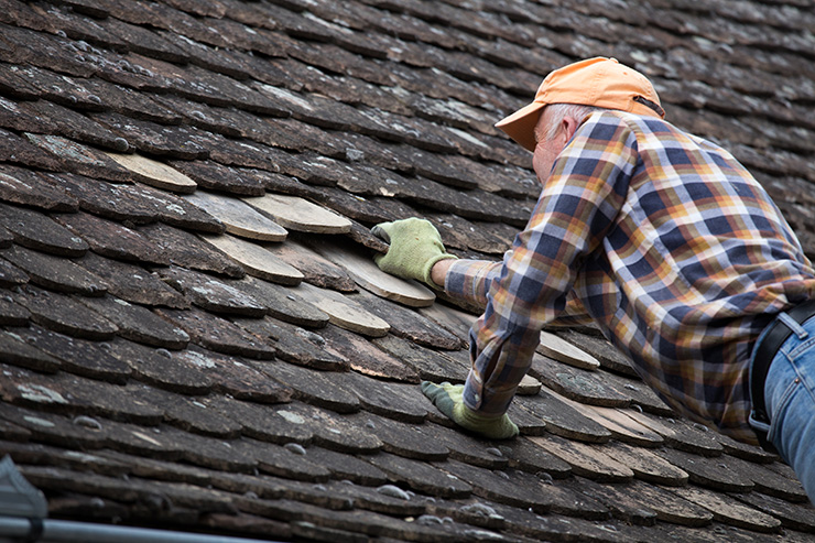 Picture of a man repairing a roof