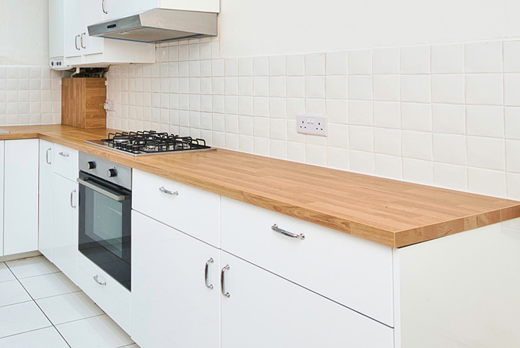 Picture of a white tiled kitchen with plug sockets installed