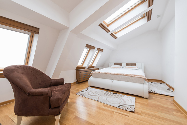 Picture of a bedroom loft conversion with multiple Velux roof windows