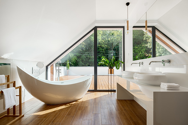 Picture of a loft converted into a bathroom with a large window and wooden floors