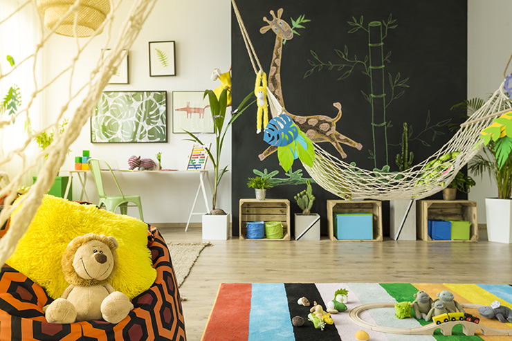 Jungle themed kids room with hammock bed and blackboard chalk painted wall.
