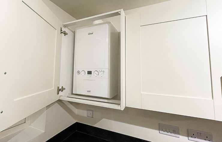 Picture of a small boiler inside a cabinet 