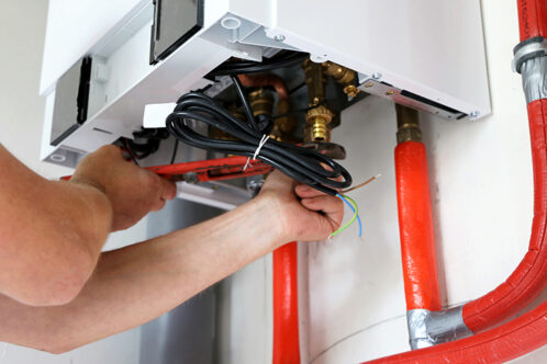 Picture of a heating engineer installing a boiler