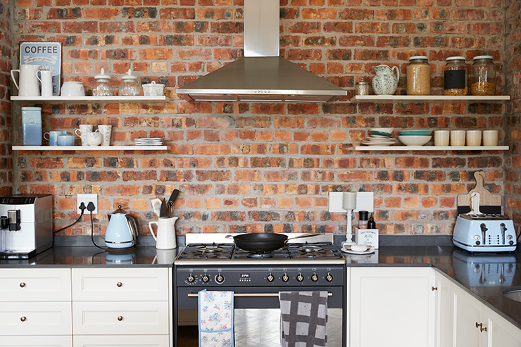 Picture of a kitchen with exposed brick walls 