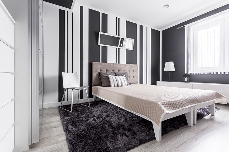 Picture of a bedroom with striped black and white walls
