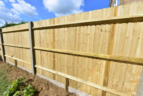 Picture of a wooden garden fence with the blue sky above it