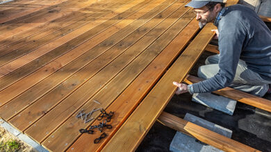 Picture of a tradesperson installing a wooden garden deck