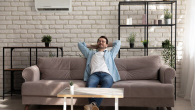 Picture of a man enjoying his air conditioning in his living room