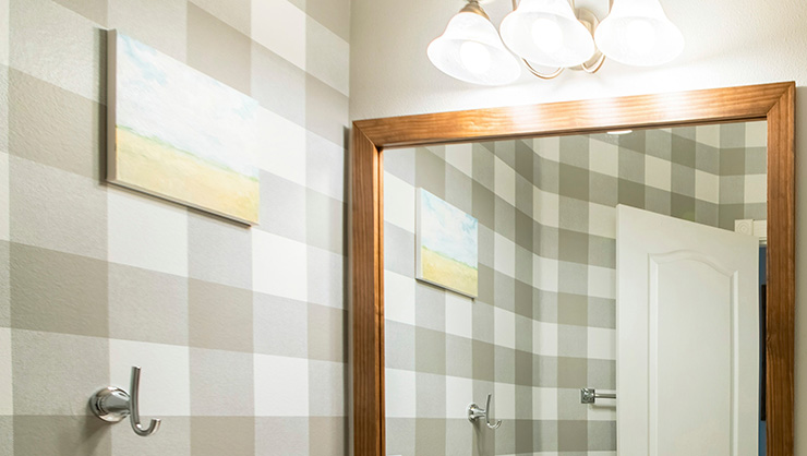 Picture of chequered wallpaper in a bathroom with a mirror 