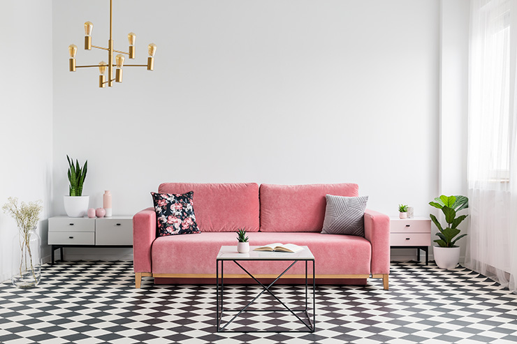 Picture of a living room with chequered floor and pink sofa