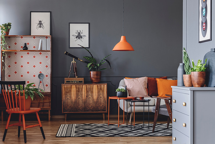 Picture of a living room with geometric patterned carpet and orange furniture