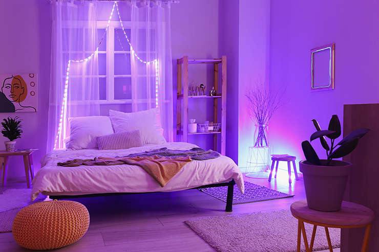 Picture of a bedroom with purple coloured lighting