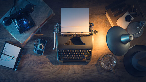 Picture of a desk with typewriter and lamp