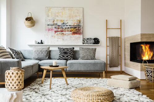 Picture of a living room with artwork and grey sofa