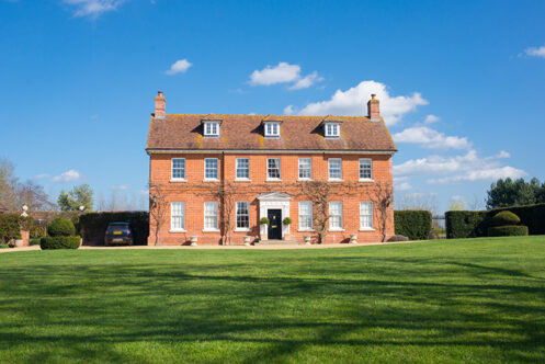 Picture of a period property with green grass 