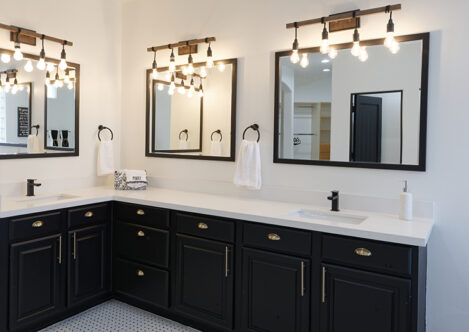 Picture of a bathroom with lights and multiple mirrors
