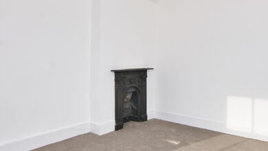 Picture of a black fireplace in a white room