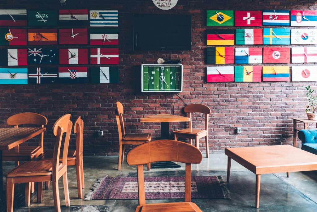Picture of a cafe with a world cup theme and flag clocks on walls