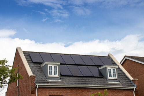 Picture of a solar powered house with panels on roof