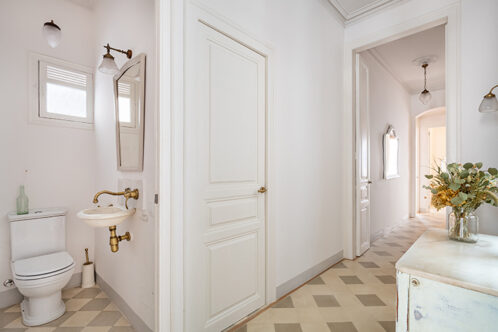 Picture of a small bathroom by a hallway